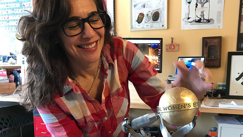 Trophy designer Lisa Issenberg smiling while making the trophy.